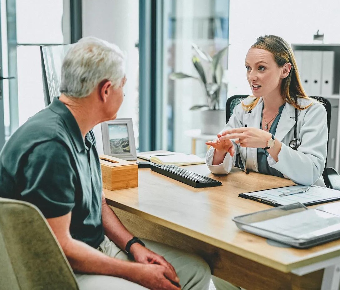 Doctor consulting with a senior patient in a medical office, representing Medicare Part B outpatient care