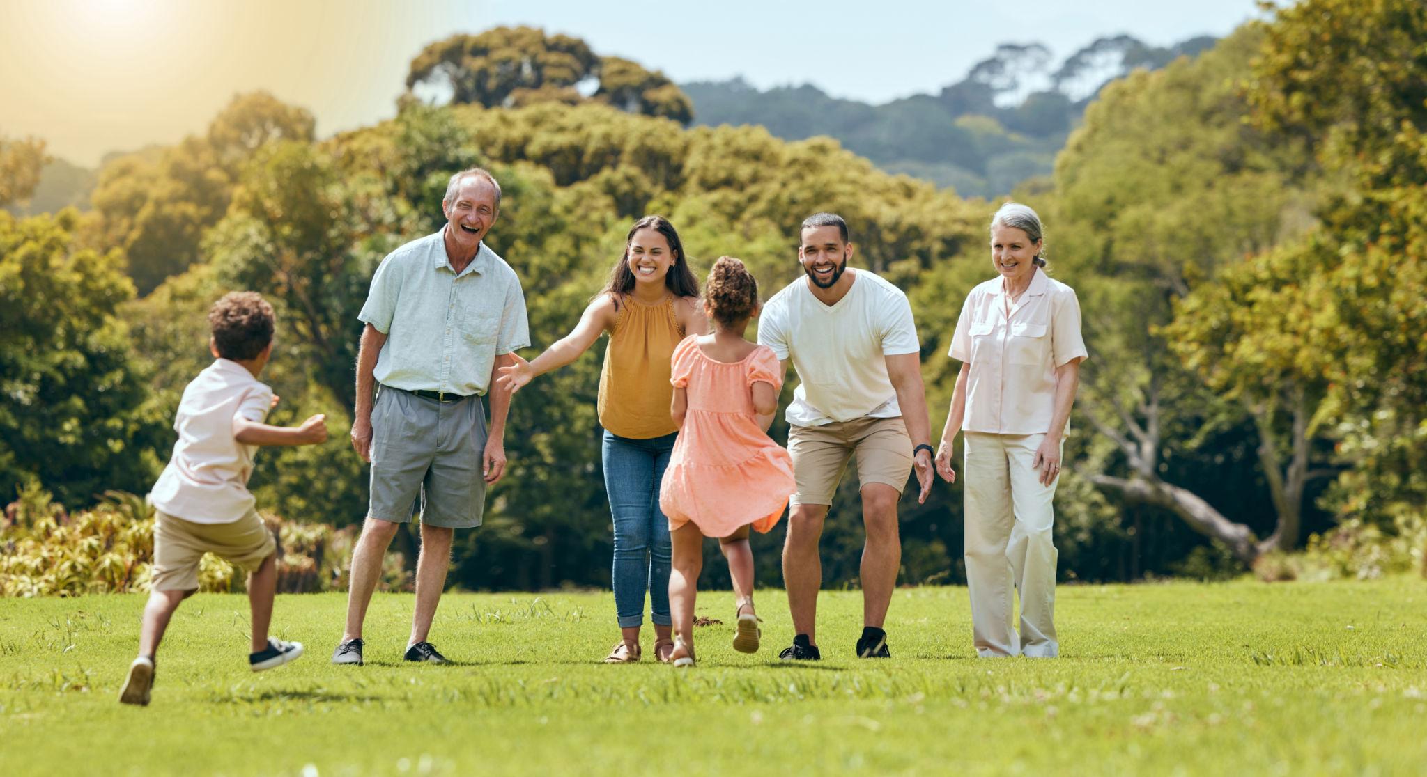 Multigenerational family walking together outdoors, representing individual and family health coverage